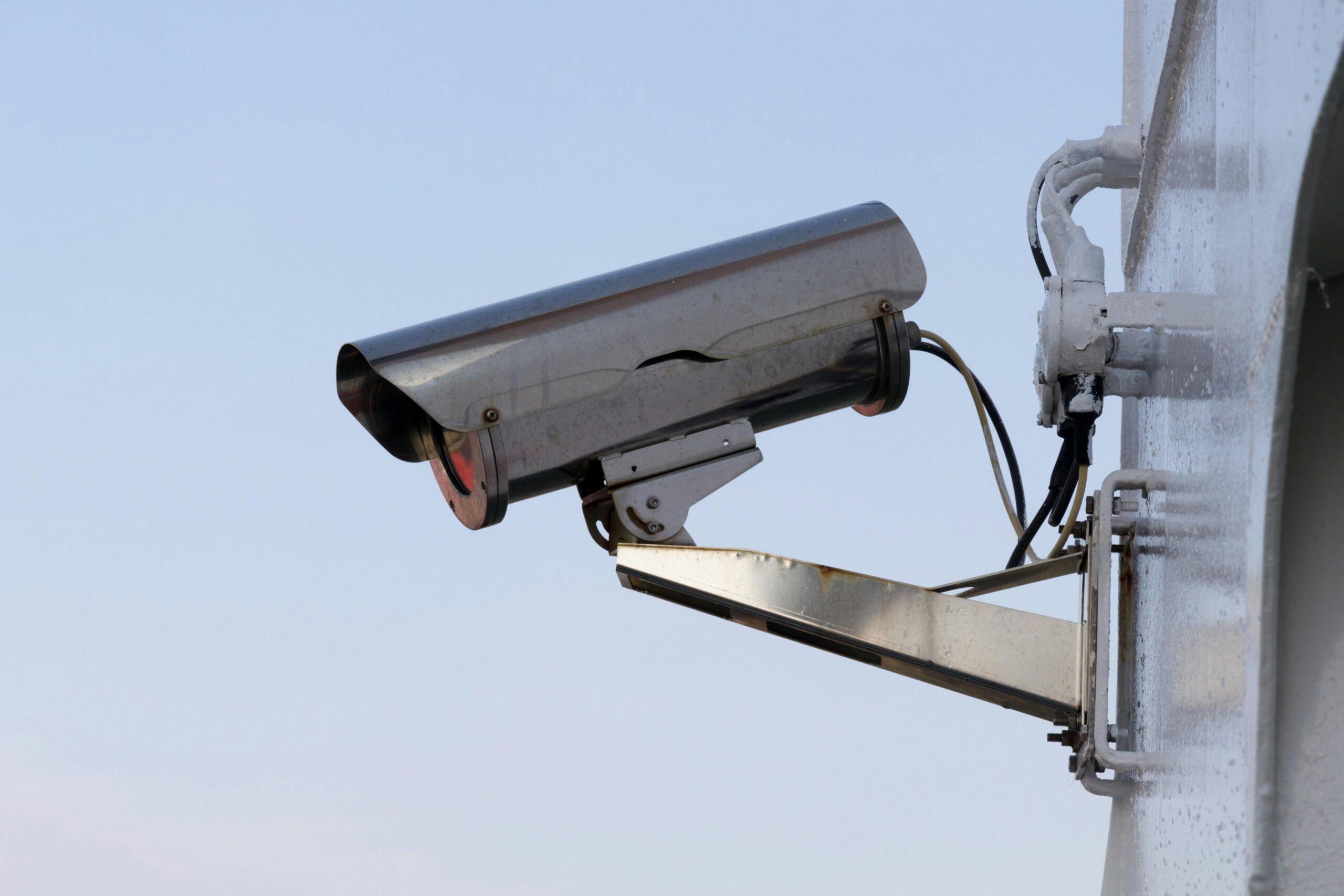 What does data protection law say about using CCTV at your home? Close-up of an outdoor CCTV camera installed on a wall for security purposes.