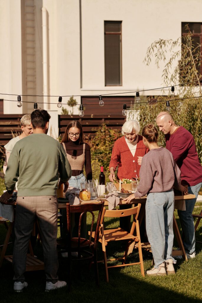 pexels-photo-5638273-5638273 Family enjoying outdoor meal and drinks in the garden.